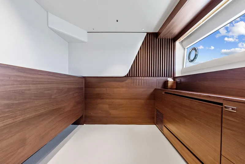 Slide: The Image of Luxurious interior of 2024 Princess Y72 Motor Yacht with elegant wood paneling and large window. - 24