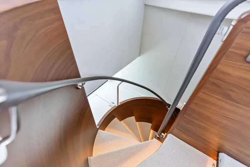 Slide: The Image of Spiral staircase on 2024 Princess Y72 Motor Yacht, featuring elegant wood and modern design. - 28