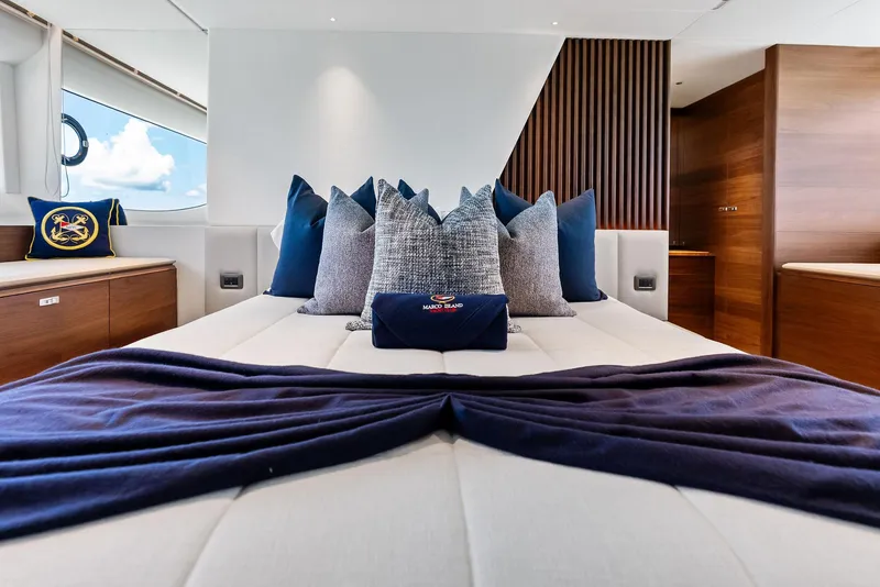 Slide: The Image of Luxurious bedroom interior of 2024 Princess Y72 Motor Yacht with elegant pillows and wooden accents. - 32