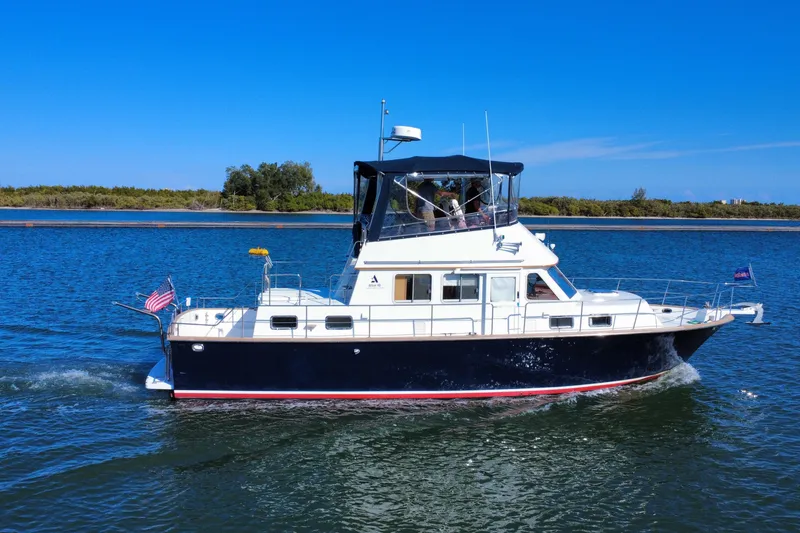 Slide: The Image of 2006 Albin 40 North Sea Cutter cruising on a sunny day, displaying American flag. - 11