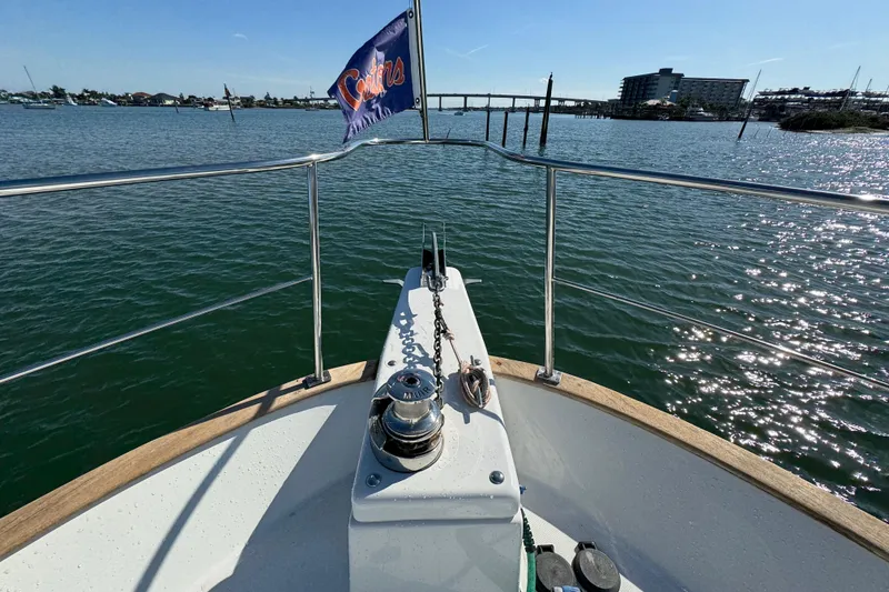 Slide: The Image of Bow view of 2006 Albin 40 North Sea Cutter on calm water, with a flag waving. - 19