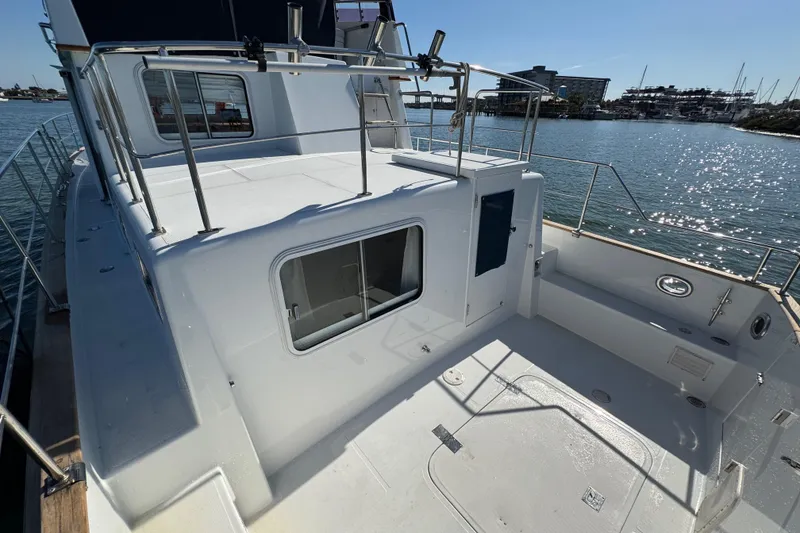 Slide: The Image of 2006 Albin 40 North Sea Cutter on calm water, showcasing deck and railing. - 21