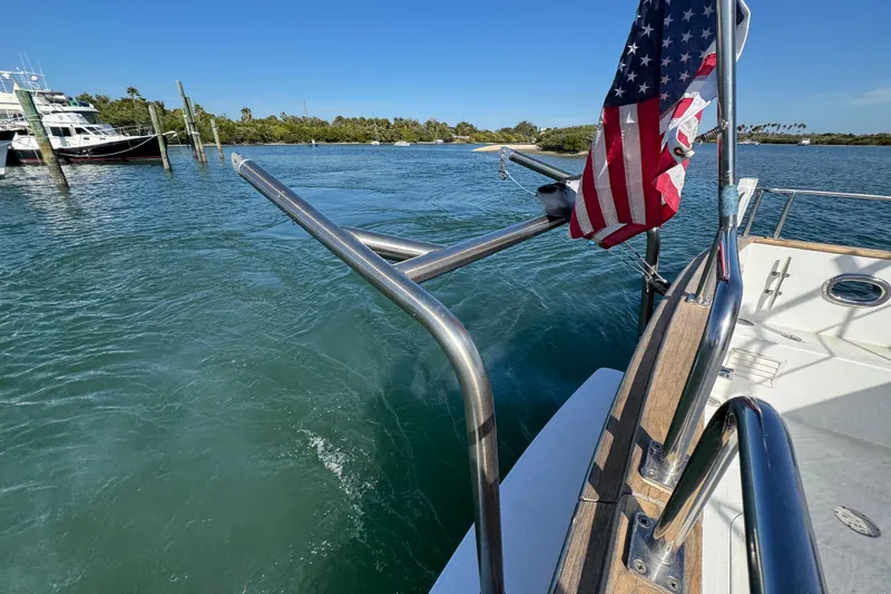 Slide: The Image of 2006 Albin 40 North Sea Cutter on water, American flag, sunny day. - 25