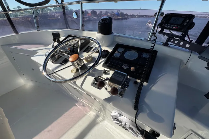 Slide: The Image of Helm of 2006 Albin 40 North Sea Cutter with steering wheel and navigation controls. - 28