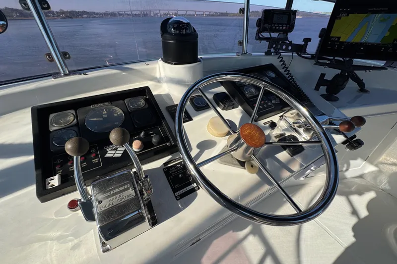 Slide: The Image of Control panel of a 2006 Albin 40 North Sea Cutter with steering wheel and navigation instruments. - 29