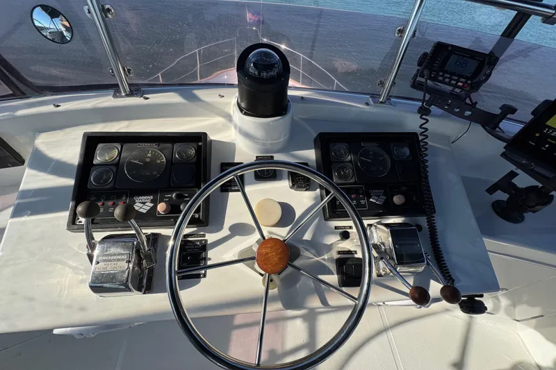 Slide: The Image of Helm of 2006 Albin 40 North Sea Cutter with steering wheel and navigation controls. - 30