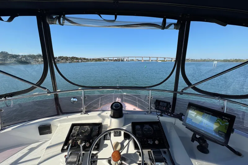 Slide: The Image of Helm view of 2006 Albin 40 North Sea Cutter on calm waters with bridge in background. - 31