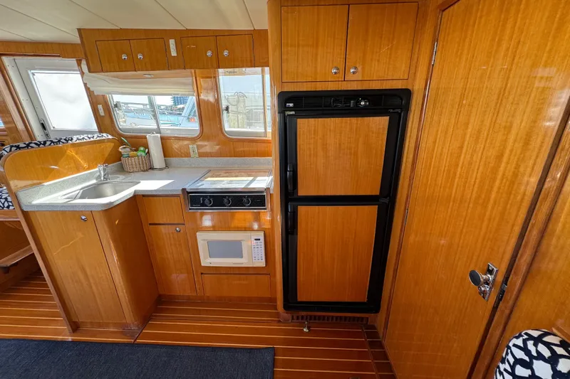 Slide: The Image of Interior of 2006 Albin 40 North Sea Cutter with kitchen amenities and wooden cabinetry. - 46