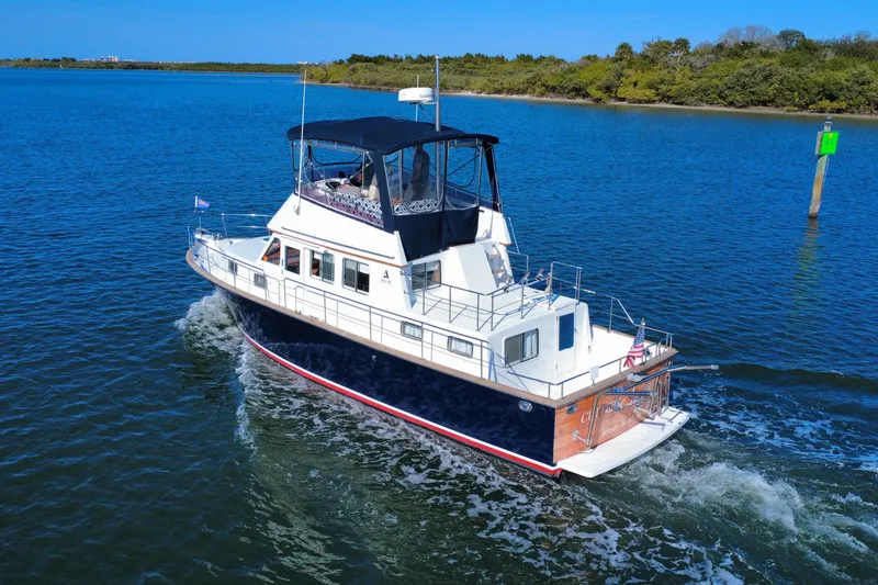 Slide: The Image of 2006 Albin 40 North Sea Cutter cruising on a serene blue waterway. - 5