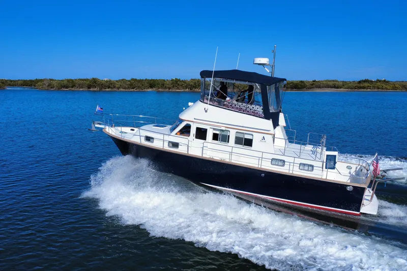 Slide: The Image of 2006 Albin 40 North Sea Cutter cruising on a sunny day, creating waves. - 6