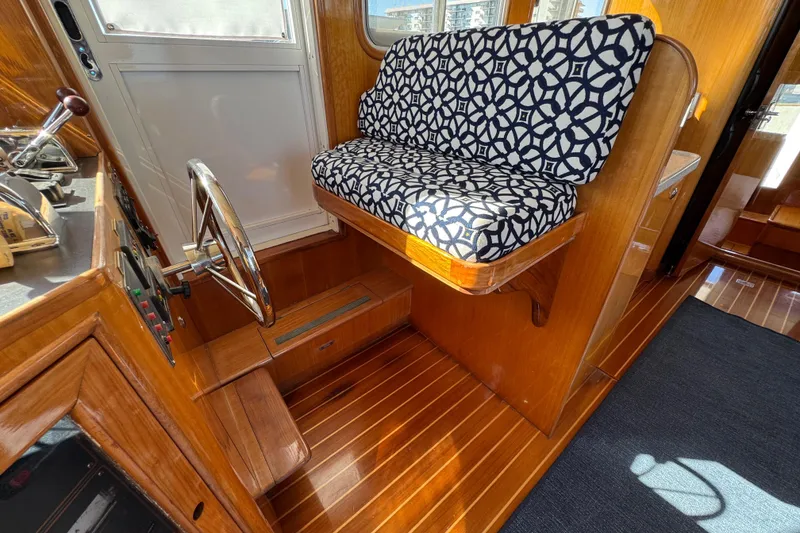Slide: The Image of Interior of 2006 Albin 40 North Sea Cutter with patterned seating and wooden flooring. - 60