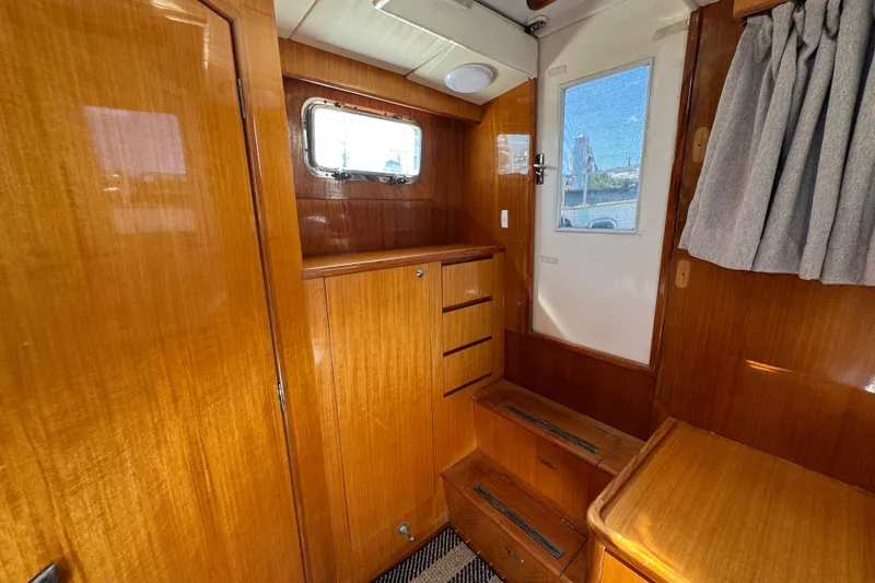 Slide: The Image of Interior of 2006 Albin 40 North Sea Cutter with wooden cabinetry and window. - 70