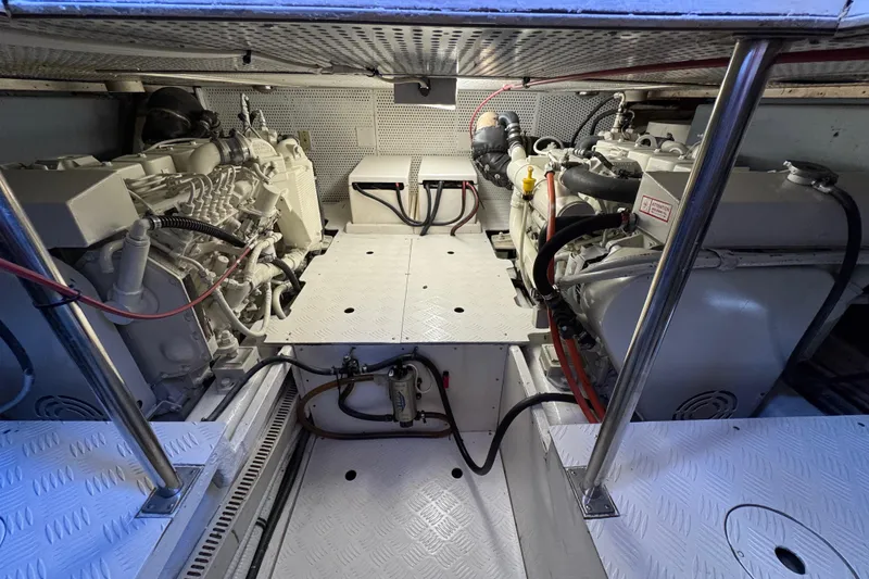 Slide: The Image of Engine room of a 2006 Albin 40 North Sea Cutter, showcasing dual engines and mechanical components. - 73