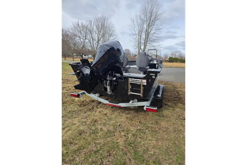 Slide: The Image of 2026 Alumacraft Classic 165 CS boat on trailer, parked on grassy area. - 4