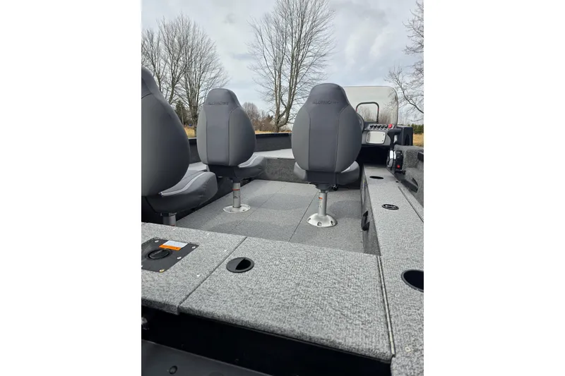 Slide: The Image of 2026 Alumacraft Classic 165 CS boat interior with gray seating and console. - 6