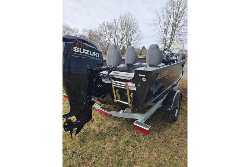 Slide: The Image of 2026 Alumacraft Classic 165 CS boat with Suzuki outboard motor on trailer. - 7