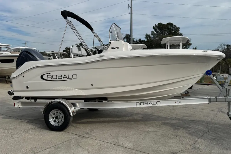 The Image of 2026 Robalo R180 Center Console boat on trailer, side view. - 0