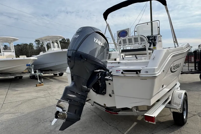 Slide: The Image of 2026 Robalo R180 Center Console boat with Yamaha engine on trailer. - 2