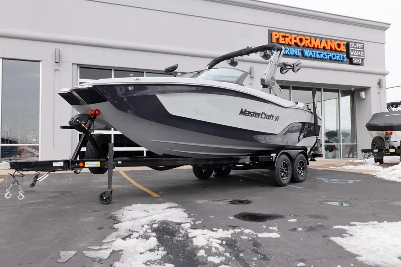 The Image of 2026 MasterCraft XT22 boat on trailer at Performance Marine Watersports dealership. - 0