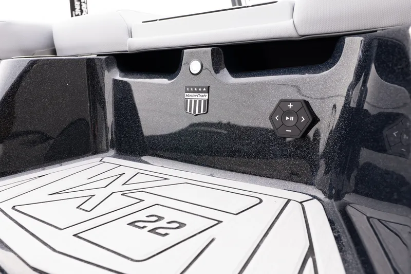 Slide: The Image of 2026 MasterCraft XT22 boat interior with control panel and logo detail. - 17