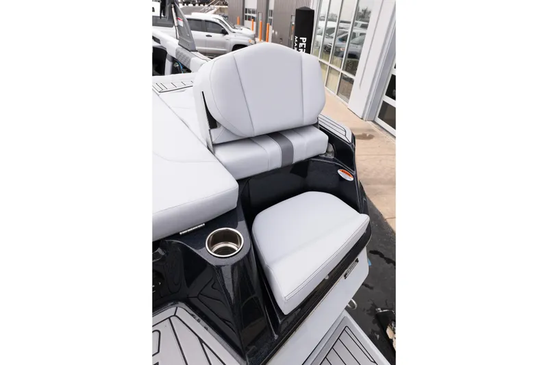 Slide: The Image of 2026 MasterCraft XT22 boat interior with sleek seating and cup holder. - 18