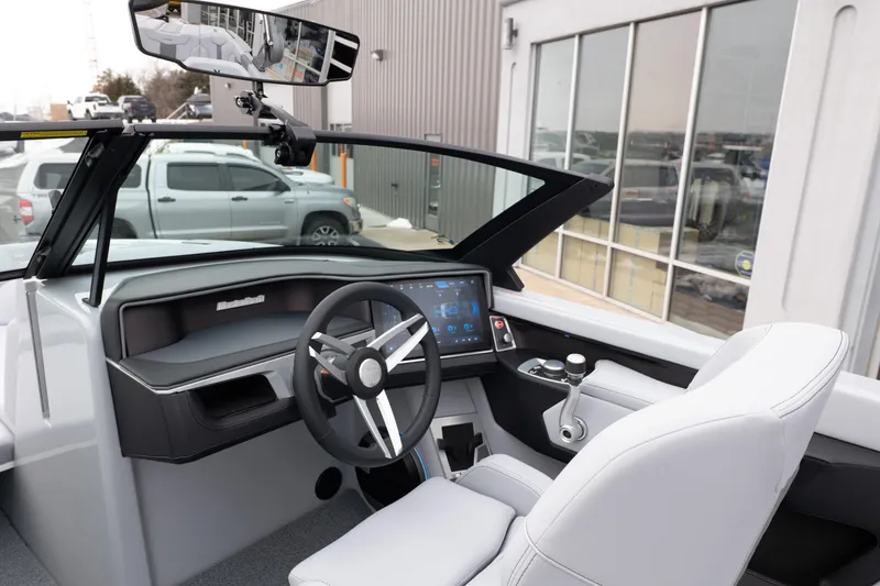 Slide: The Image of 2026 MasterCraft XT22 boat interior with modern dashboard and steering wheel. - 26