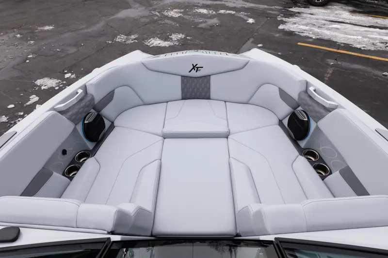 Slide: The Image of 2026 MasterCraft XT22 boat interior with luxurious white seating and cup holders. - 33
