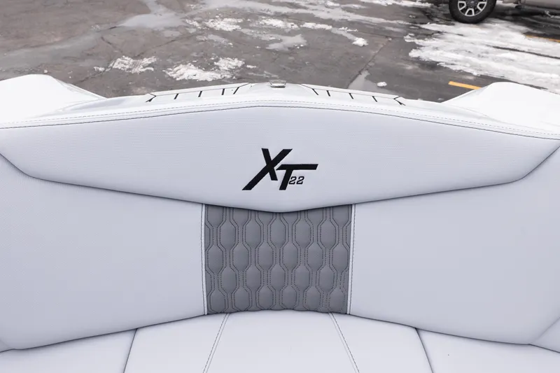 Slide: The Image of 2026 MasterCraft XT22 boat interior with logo, featuring sleek white and gray upholstery. - 38