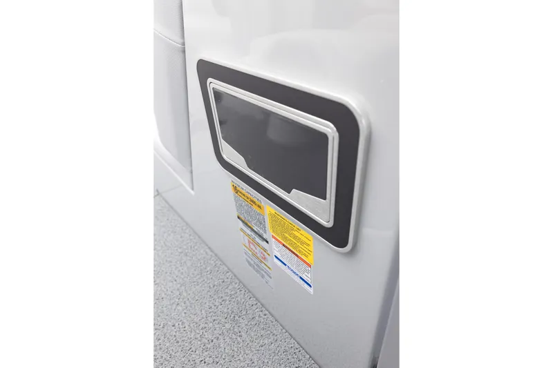 Slide: The Image of 2026 MasterCraft XT22 interior detail with safety labels and storage compartment. - 39