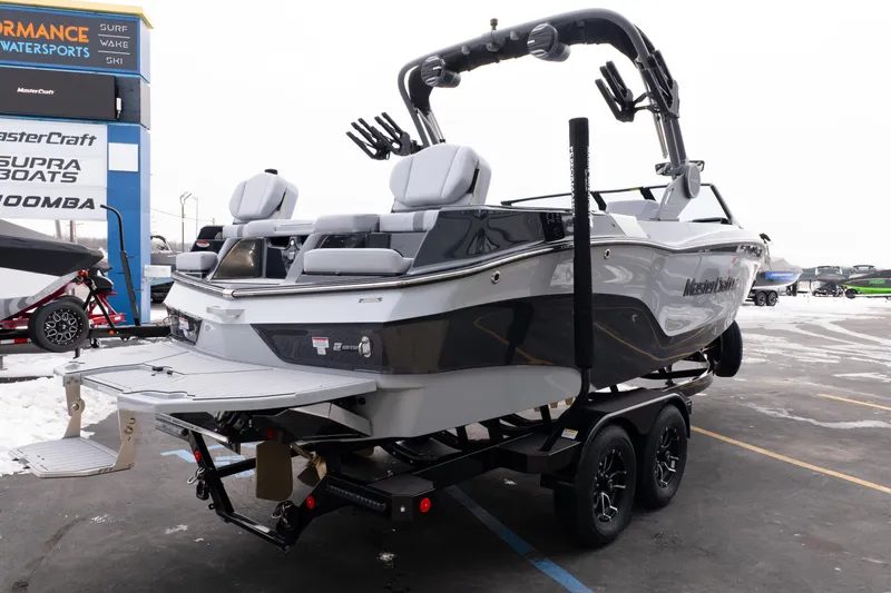 Slide: The Image of 2026 MasterCraft XT22 boat on trailer at dealership, showcasing sleek design and modern features. - 6