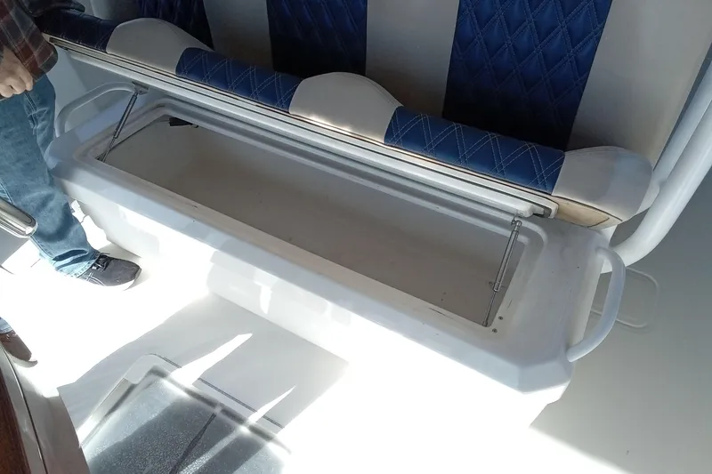 Slide: The Image of 2022 Invincible 39 Open Fisherman boat seat with storage compartment open. - 16