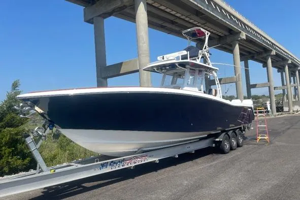Slide: The Image of 2022 Invincible 39 Open Fisherman boat on trailer under bridge. - 2