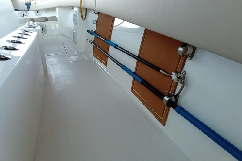 Slide: The Image of 2022 Invincible 39 Open Fisherman interior with fishing rod holders and seating. - 20