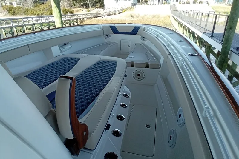 Slide: The Image of 2022 Invincible 39 Open Fisherman boat interior with cushioned seating and rod holders. - 21