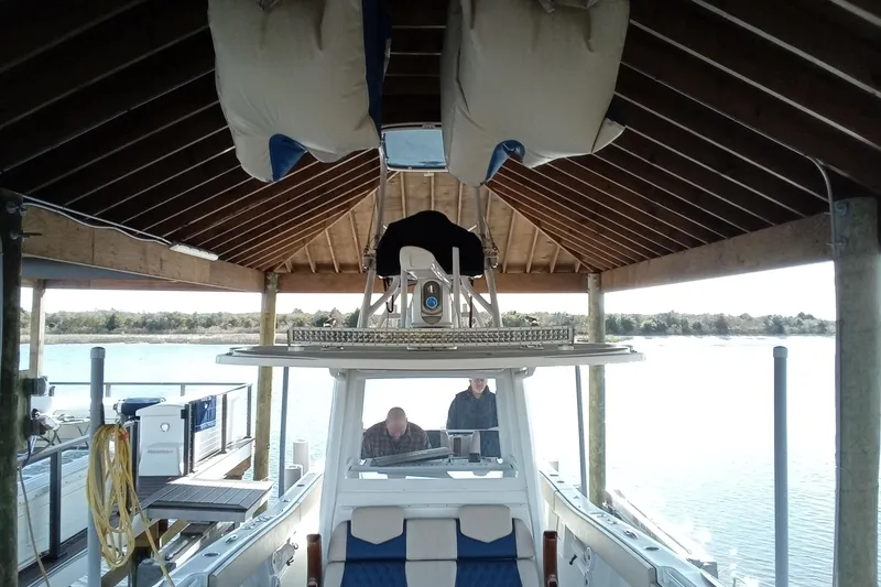 Slide: The Image of 2022 Invincible 39 Open Fisherman docked under wooden shelter. - 27