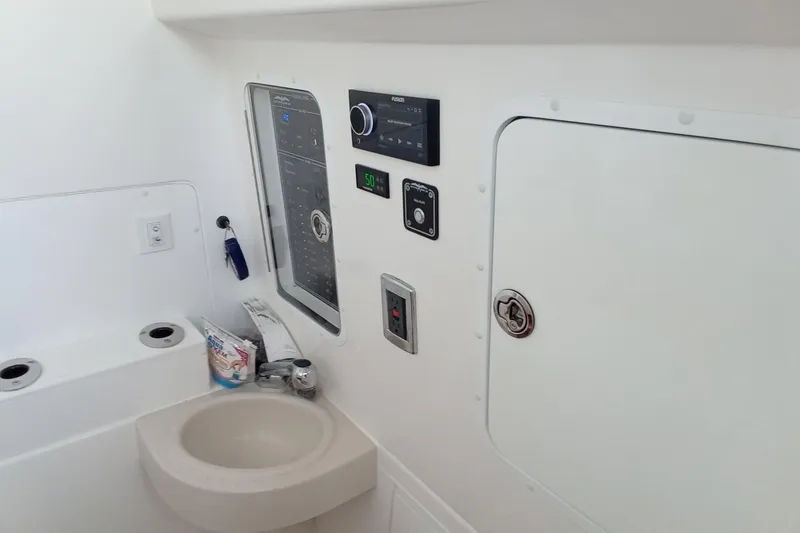 Slide: The Image of 2022 Invincible 39 Open Fisherman interior with control panel and sink. - 31