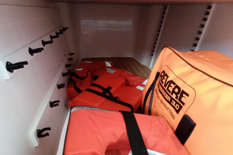 Slide: The Image of Storage compartment with life jackets and safety gear on a 2022 Invincible 39 Open Fisherman. - 32