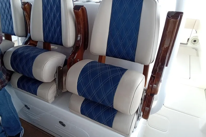 Slide: The Image of Luxurious seating on 2022 Invincible 39 Open Fisherman boat with blue and beige upholstery. - 37