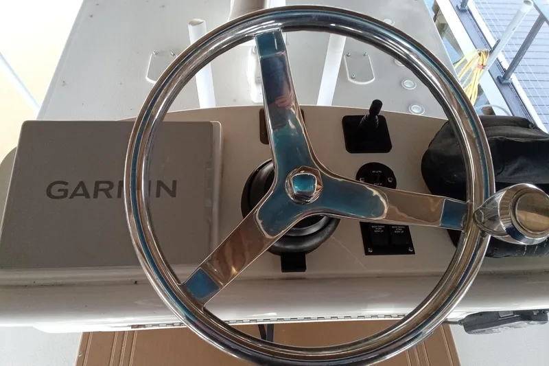 Slide: The Image of Steering wheel and controls of 2022 Invincible 39 Open Fisherman boat with Garmin system. - 40
