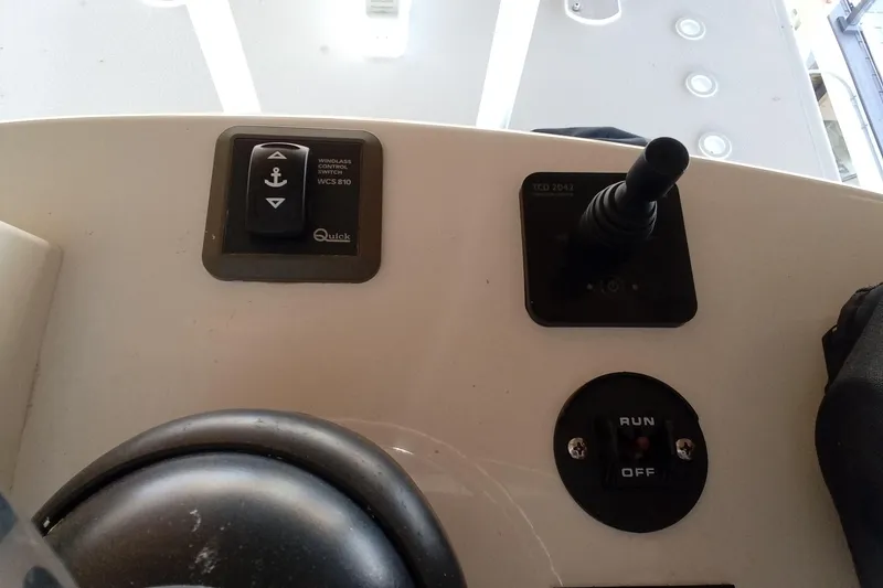 Slide: The Image of Control panel of 2022 Invincible 39 Open Fisherman boat with switches and joystick. - 42