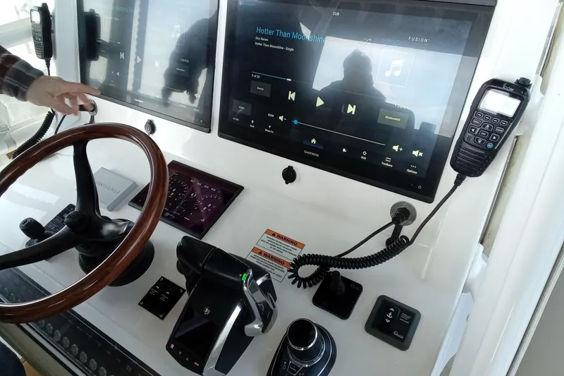 Slide: The Image of 2022 Invincible 39 Open Fisherman dashboard with steering wheel and electronic controls. - 45