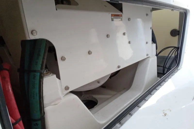 Slide: The Image of 2022 Invincible 39 Open Fisherman engine compartment with visible hoses and wiring. - 46