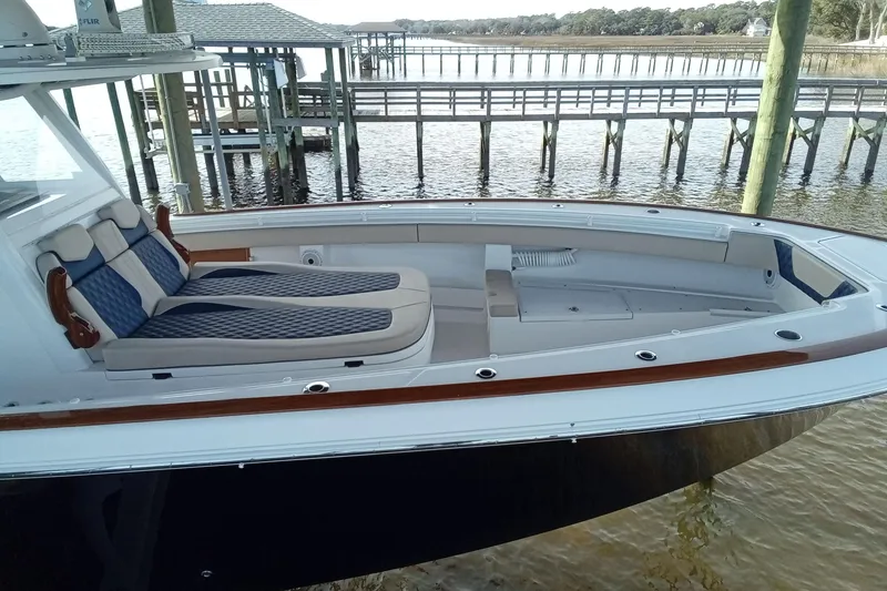Slide: The Image of 2022 Invincible 39 Open Fisherman boat docked, featuring spacious seating and sleek design. - 52