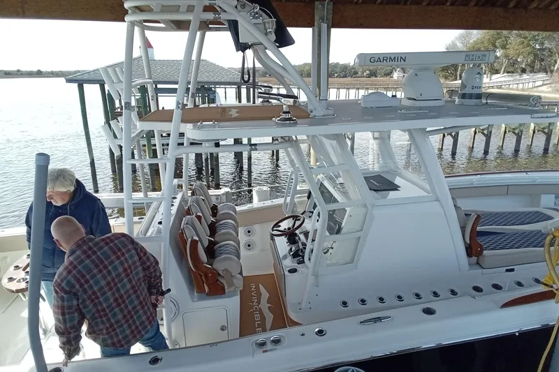 Slide: The Image of 2022 Invincible 39 Open Fisherman boat docked, featuring advanced Garmin navigation equipment. - 53