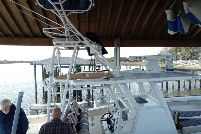 Slide: The Image of 2022 Invincible 39 Open Fisherman docked under a wooden shelter. - 54