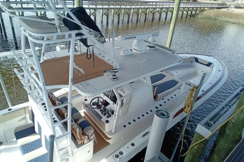 Slide: The Image of 2022 Invincible 39 Open Fisherman boat docked, featuring advanced navigation equipment and spacious seating. - 55