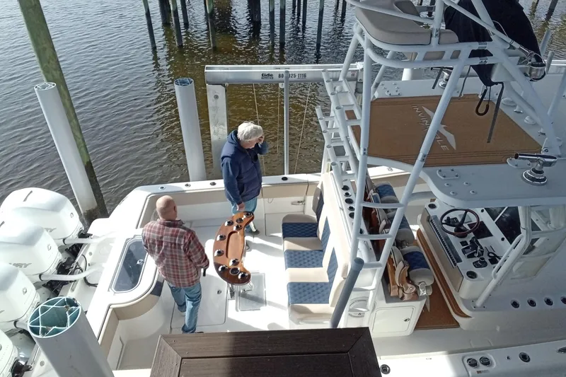 Slide: The Image of 2022 Invincible 39 Open Fisherman boat docked with two people on deck. - 56