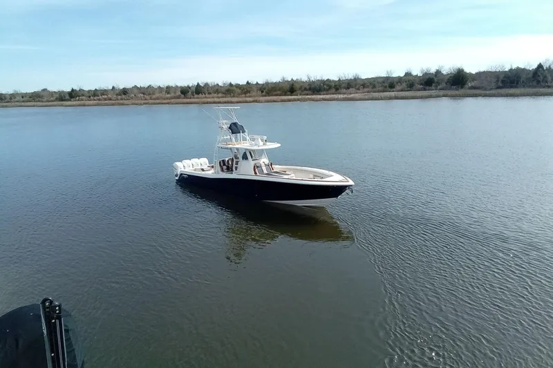 Slide: The Image of 2022 Invincible 39 Open Fisherman boat on calm water, clear sky background. - 57