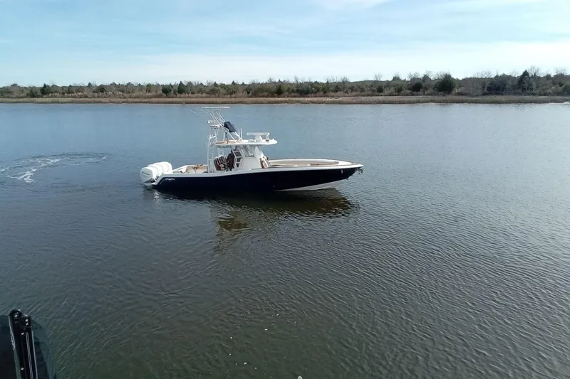 Slide: The Image of 2022 Invincible 39 Open Fisherman boat on calm water, clear sky background. - 59