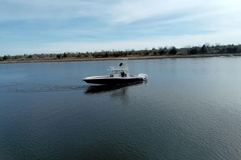 Slide: The Image of 2022 Invincible 39 Open Fisherman boat cruising on a calm lake. - 62